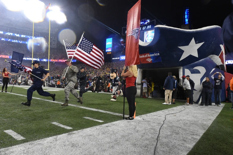 people are running onto the field and holding flags