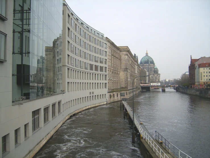 several buildings line the water on the river bank