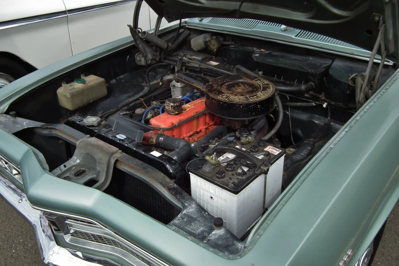 a blue car with its hood open and some equipment inside of it