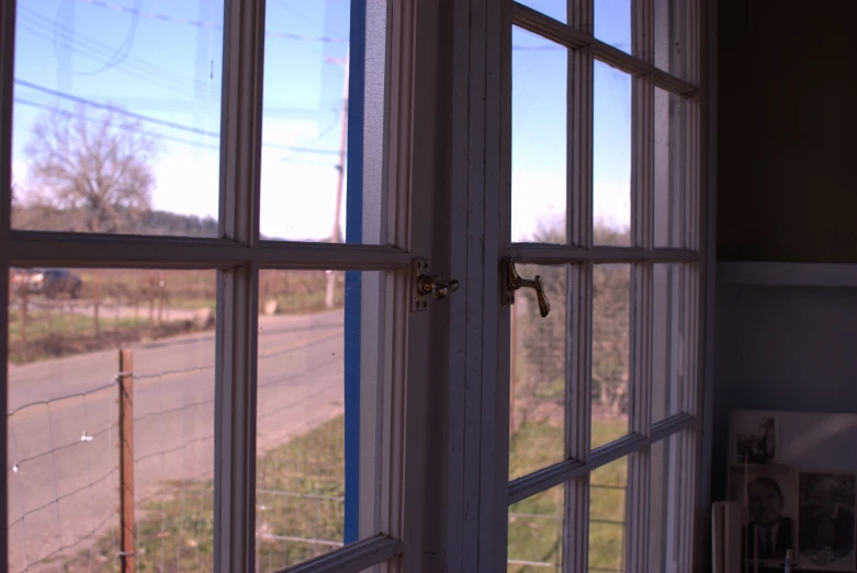 a window with the view of a country road