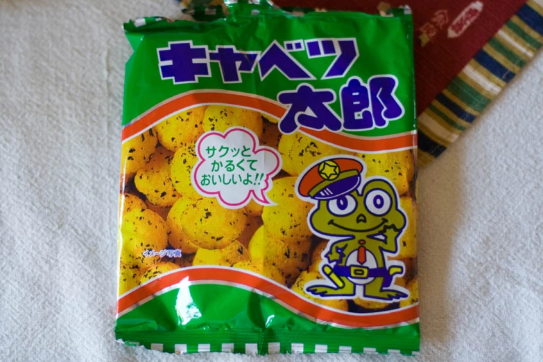 a bag of yellow sesame flavored cookies sits on a towel