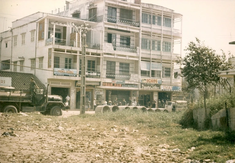 several sheep standing in front of a multi story building