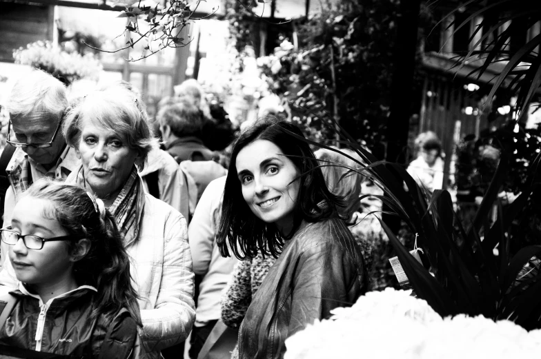 black and white image of some people sitting on a bench