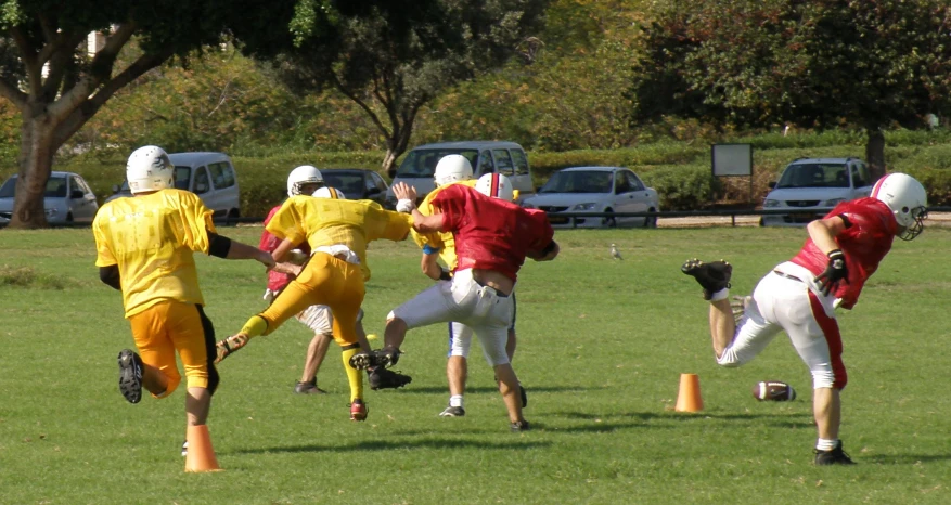 a number of football players running to catch the ball