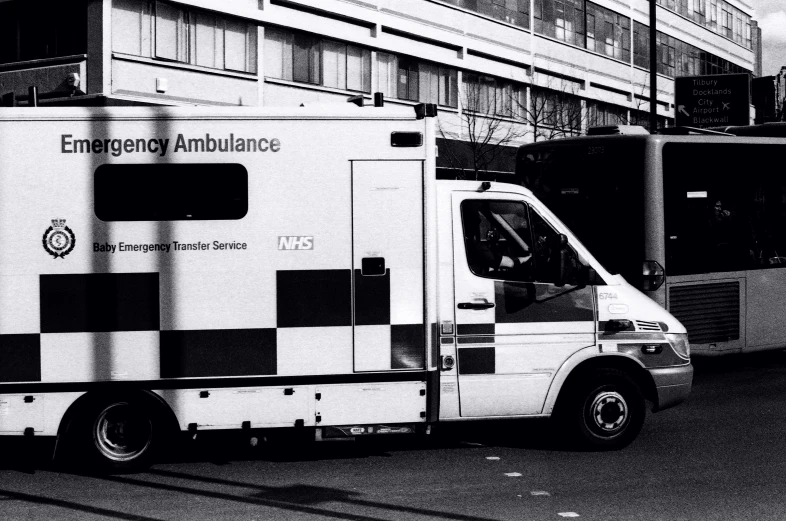 an ambulance parked by a tall building with a door