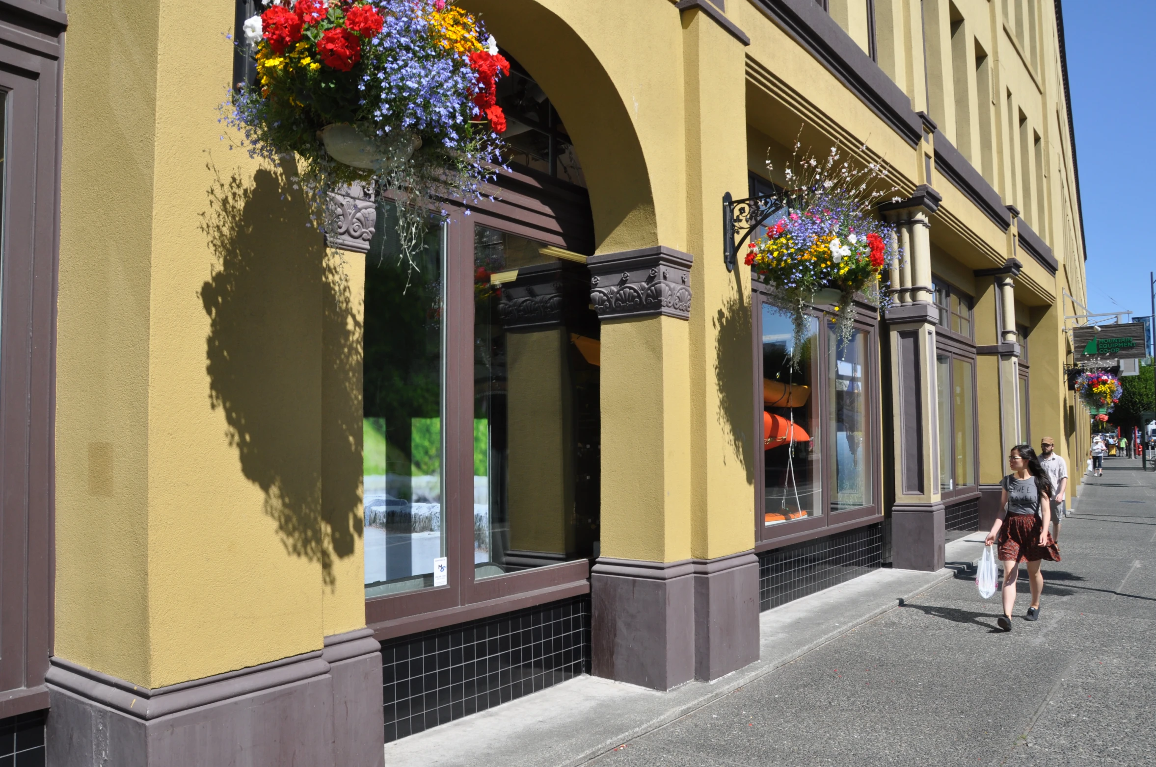 a couple walking on the street past an empty store