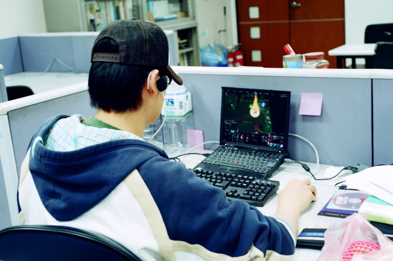 a man sitting at a desk using a computer