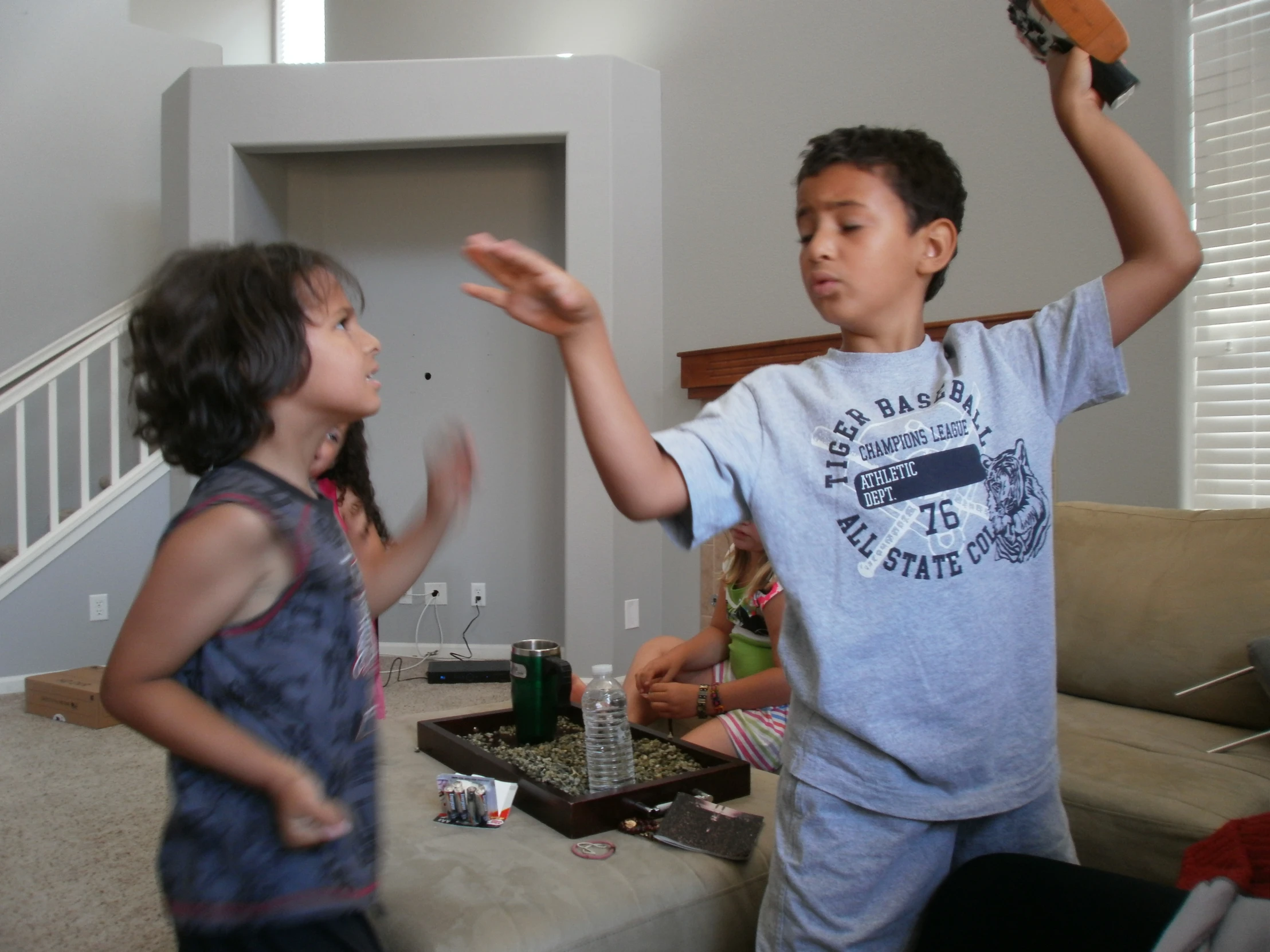 two young children play a game with a nintendo wii