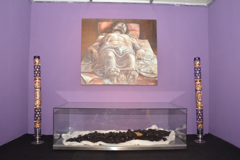 purple walls and purple lighting in front of a glass case with art on the wall