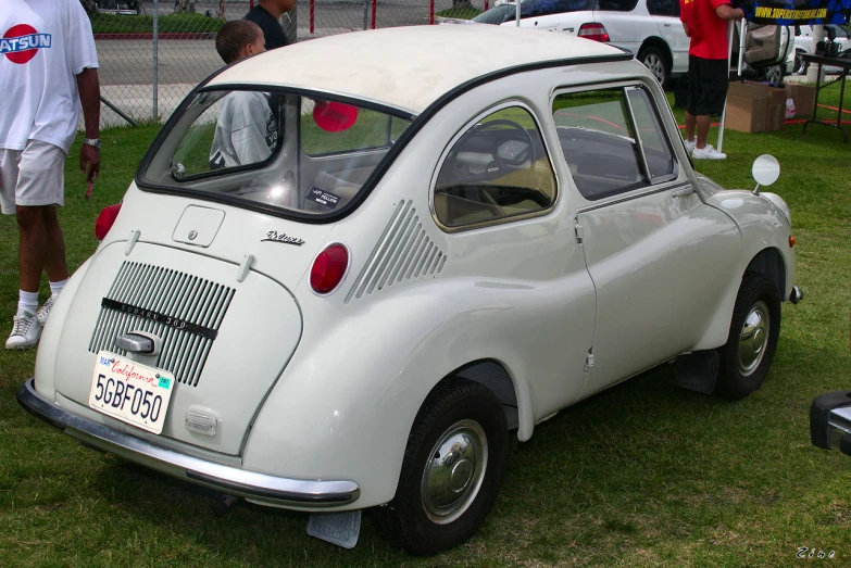 a classic car sits on display at a car show