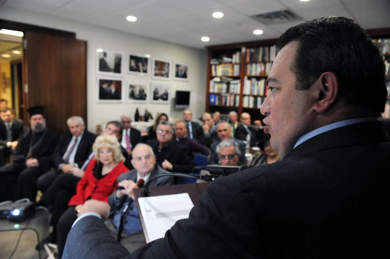 man standing in front of an audience of older people