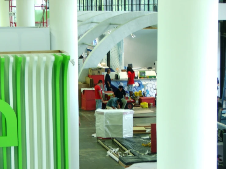 many people work on furniture in an open space