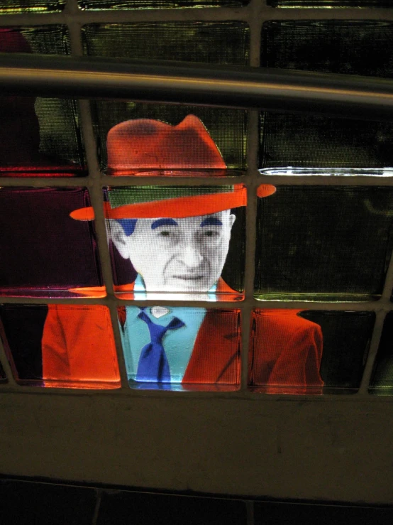 a man in a red suit with orange hats on and tie