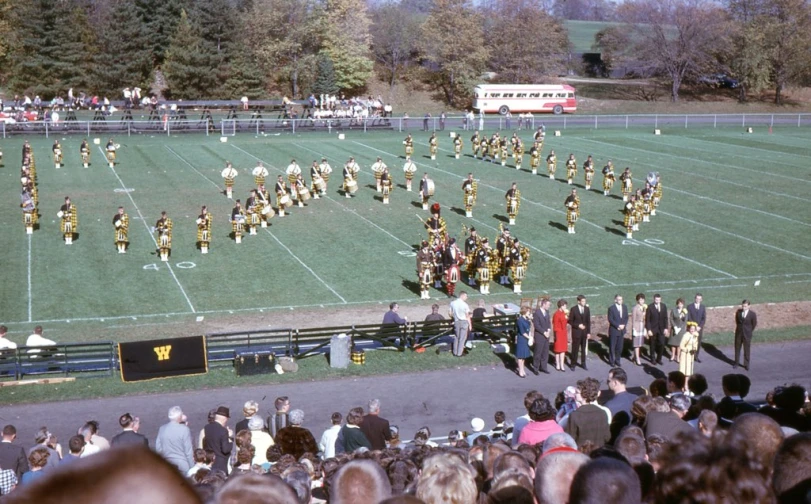 large band with yellow and gold uniforms on a field