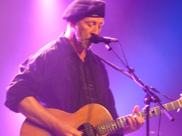 the musician is playing the guitar on stage