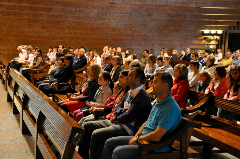 a large group of people are sitting in the aisle