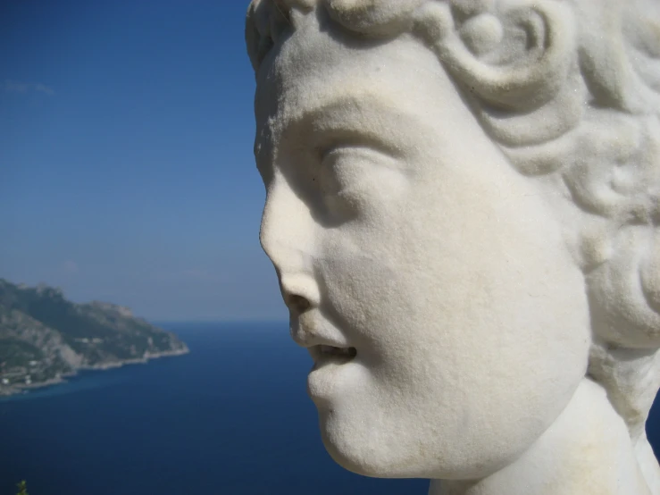 a view from the statue of a child looking down on a bay