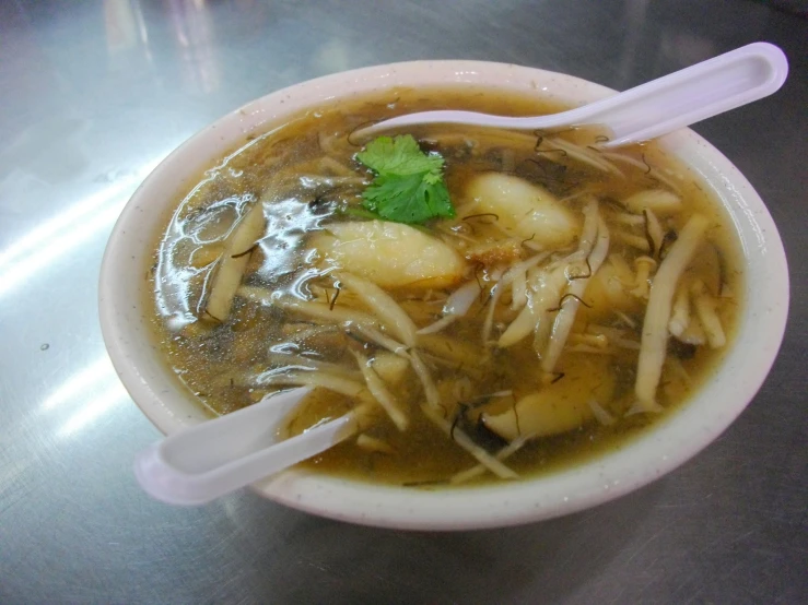 this is a bowl of food with noodles and meat