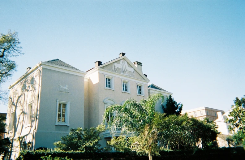 a large building sitting next to a lush green forest