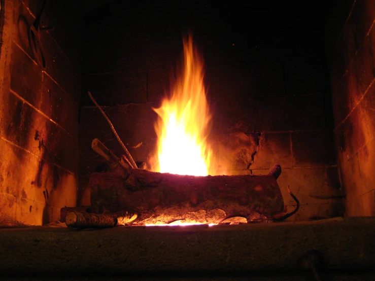 an image of a fireplace burning bright in the dark