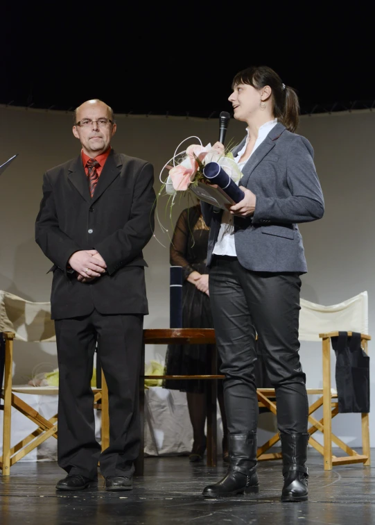 a man standing next to a woman on stage