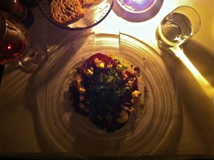 several plates and glasses of wine on a table