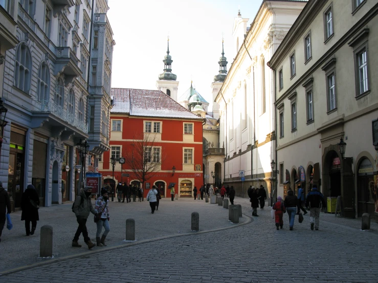 a street with pedestrians walking in between two buildings