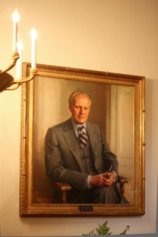 a portrait of an older man hangs on the wall