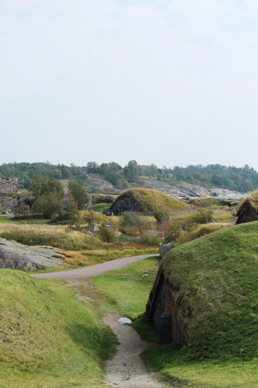 a small trail leads up into an outcropping with hay covering it