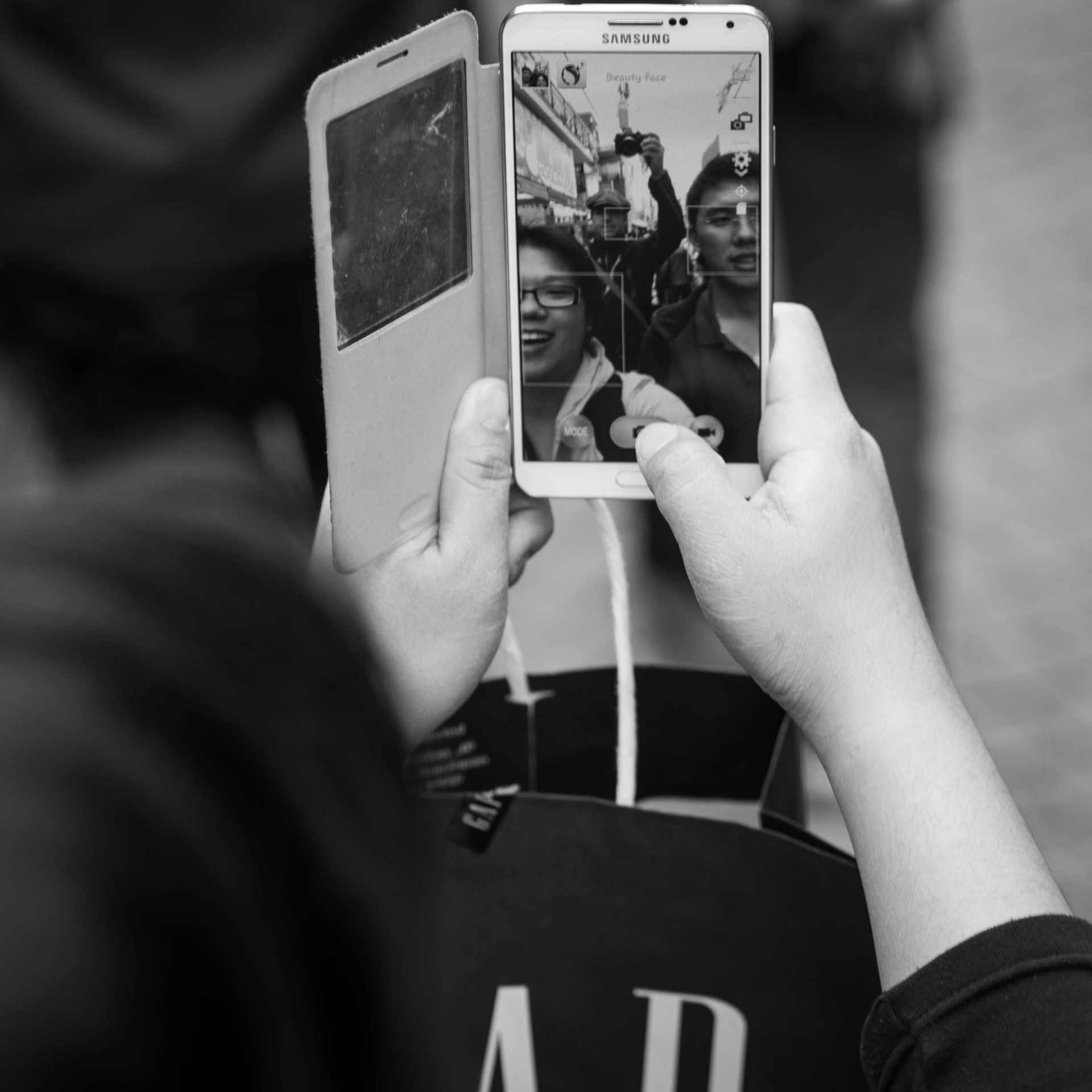 a person holding up a camera to take a po