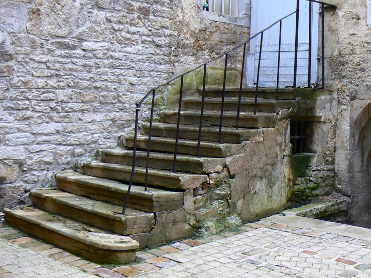 a close up of a stairway next to a building