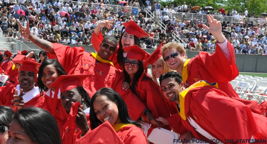 a group of students are posing for a group picture at commencement