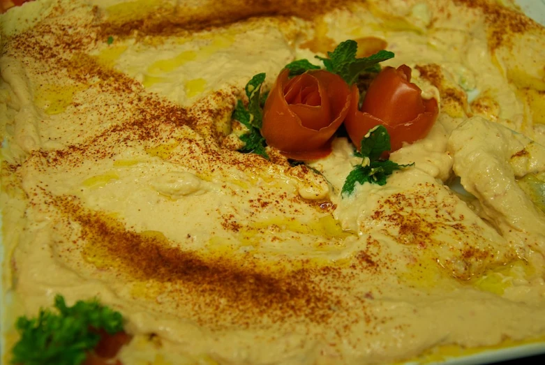 a pizza with toppings and parsley is on a plate