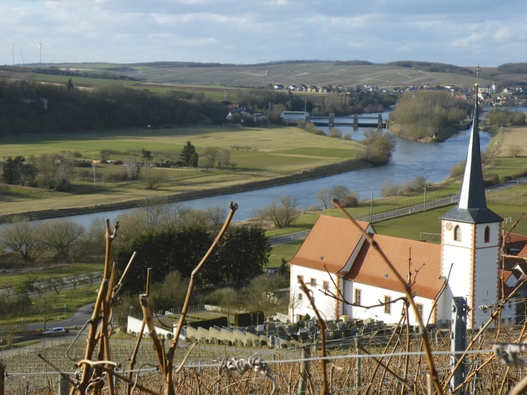 the view from a hill overlooking the river and town