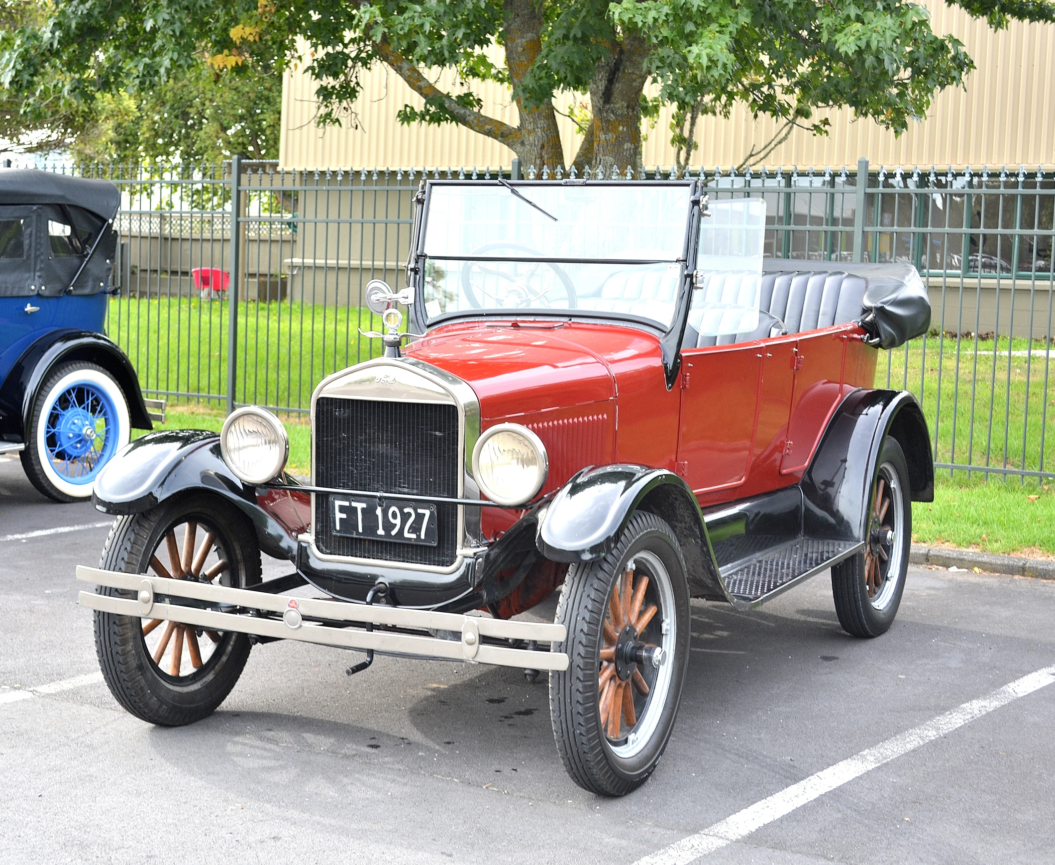 an old model ford is in a parking space