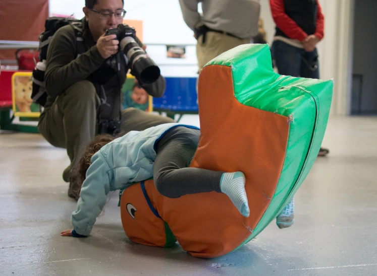 a man takes pictures of two small children