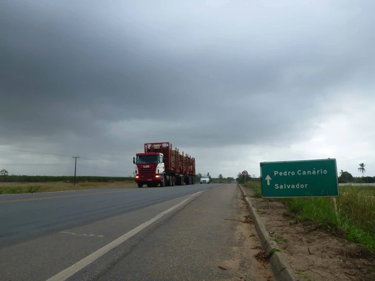 an empty road and truck with cars driving on it