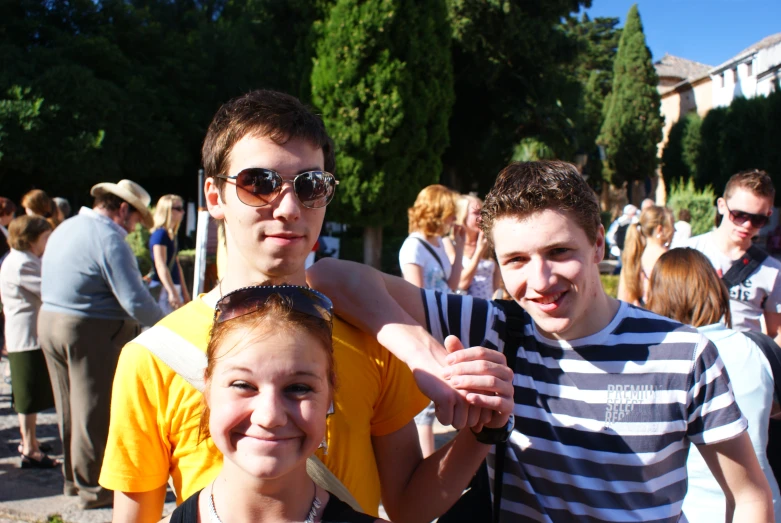 three guys posing for a po at a party