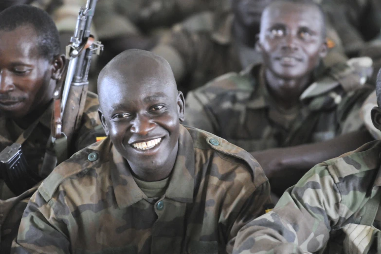 group of military personnel smiling with one another