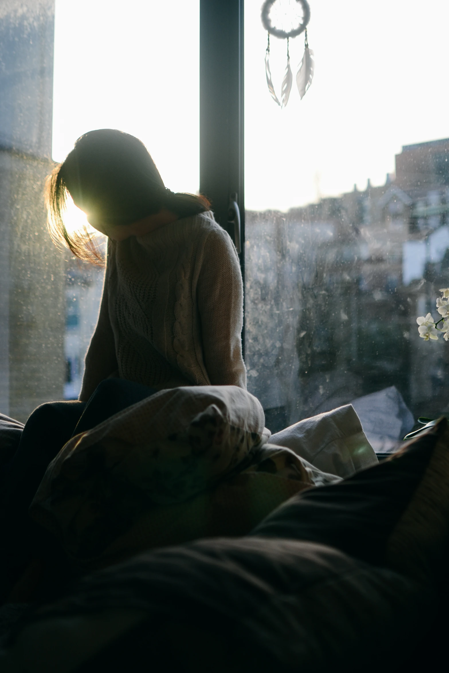 a girl with her head turned to the window