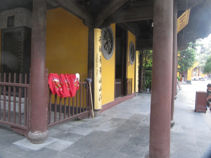 two fans and some red ribbon sitting outside the restaurant