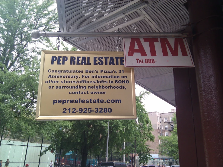 signs hanging from an awning outside a building