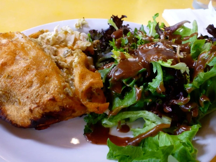 a white plate topped with food covered in gravy