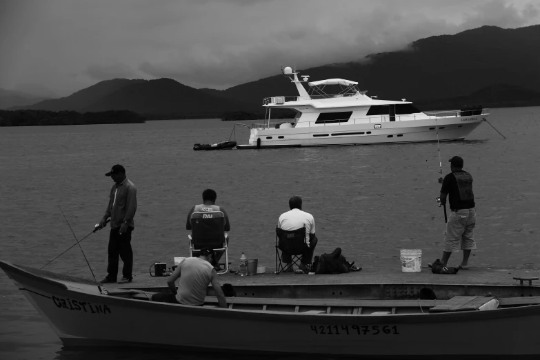 four people are preparing to jump into a boat