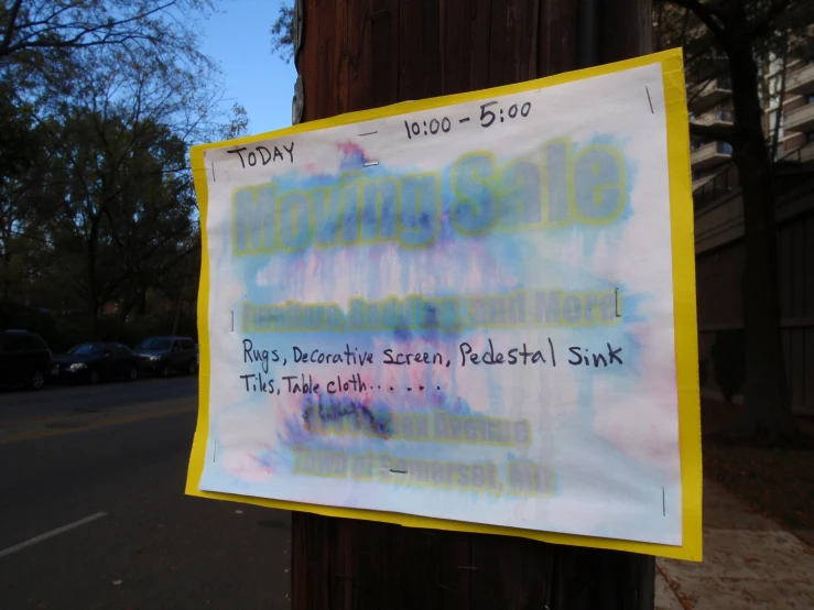 a city poster has been placed on a wooden pole