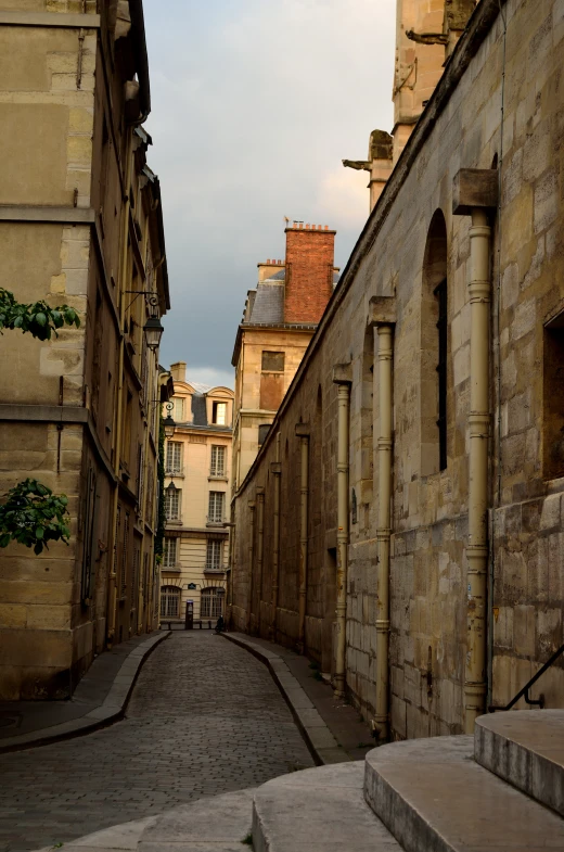 old building in the city near stairs and a cobblestone sidewalk