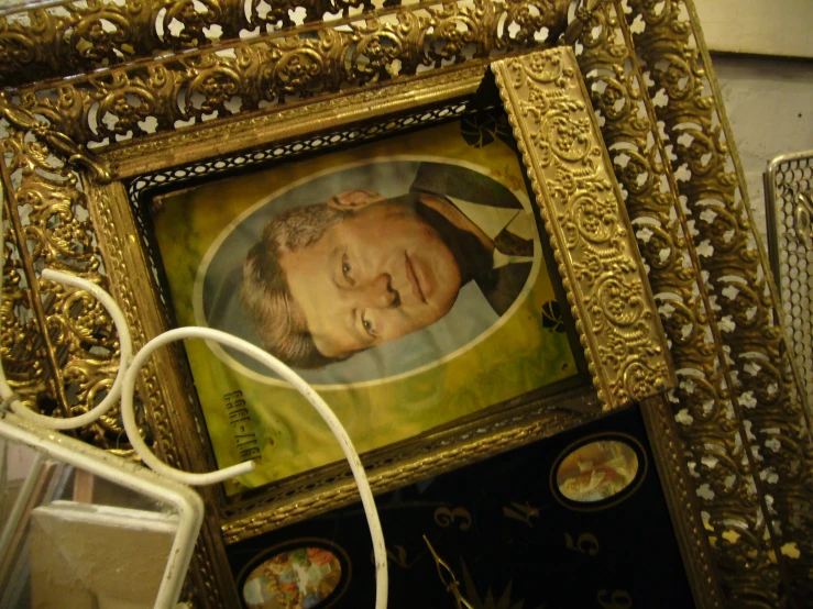 a painting in a gold frame with a picture on it