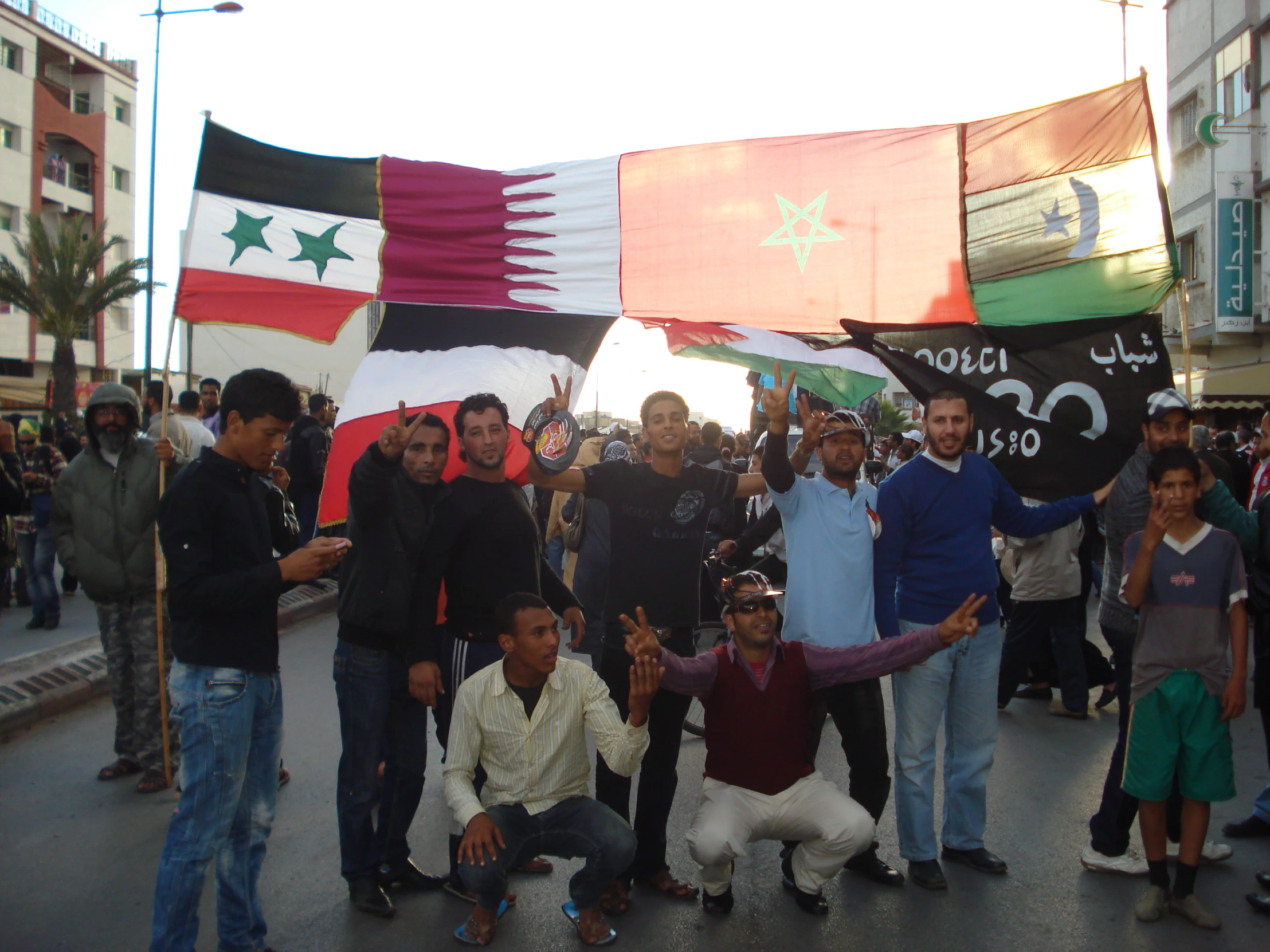 a group of men and women holding signs in a crowd