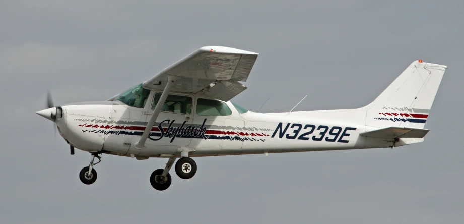 small plane flying in an overcast sky