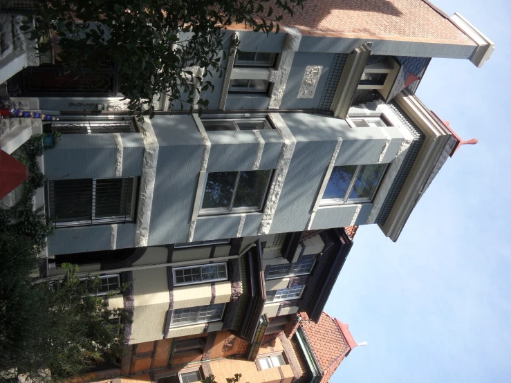 a group of three story building in front of a street